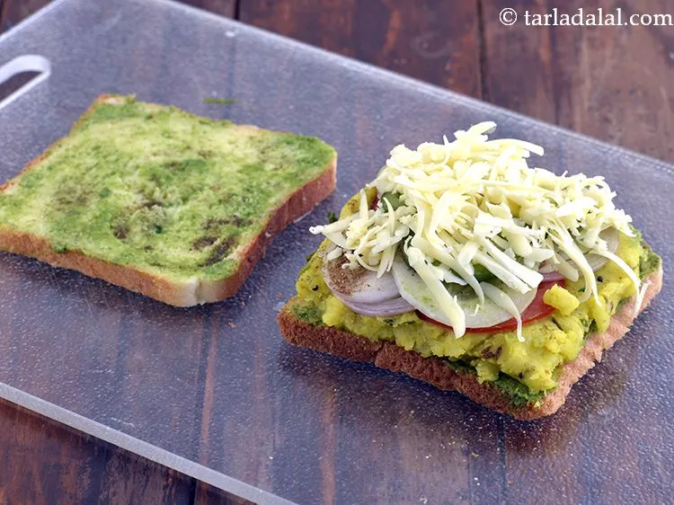 Step 27 – Sprinkle &frac14; cup of cheese evenly over it. We have used processed cheese here.&nbsp;