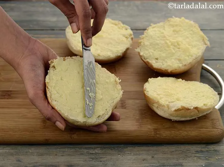 Step 7 – Spread an equal portion of the mixture evenly on each bun halve using a butter …