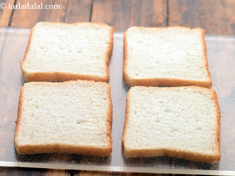 Step 14 – Place 4&nbsp;<a href="https://www.tarladalal.com/glossary-bread-219i">bread slices</a> on a dry, surface.