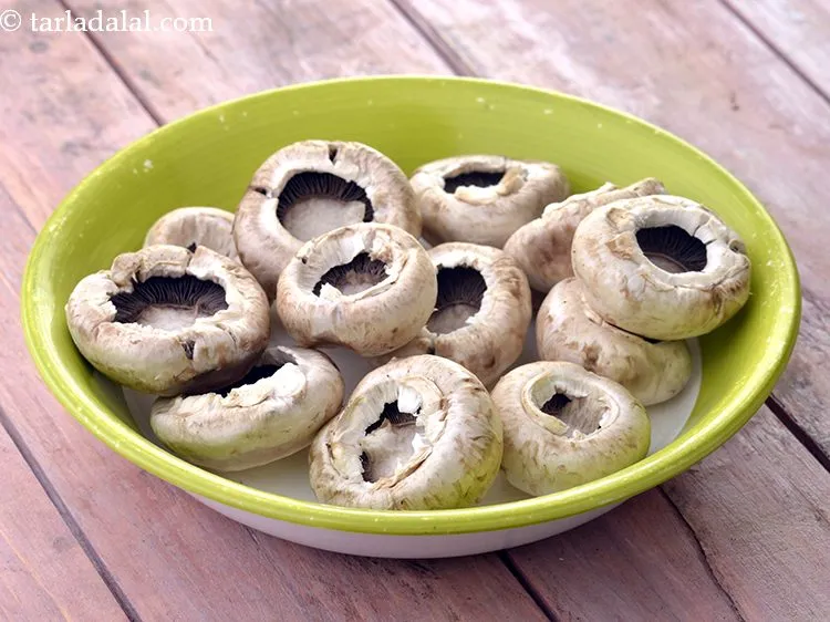 Step 4 – Remove the thick stems of each of the 14&nbsp;large sized button&nbsp;<a href="https://www.tarladalal.com/glossary-mushrooms-khumb-493i">mushrooms (khumbh)</a> and keep …