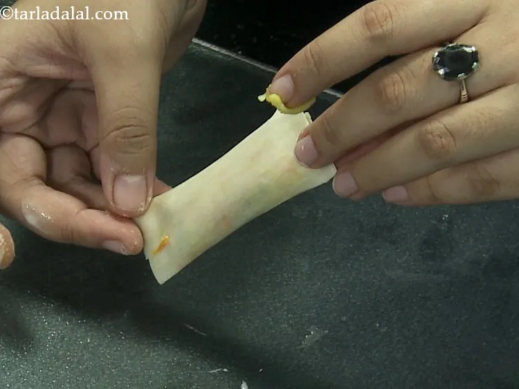 Step 19 – Seal all the edges using the plain flour-water mixture. This will ensure the filling does …