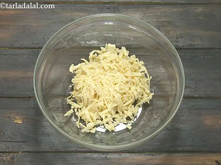 Step 3 – Take 1 cup of grated processed cheese in a bowl.