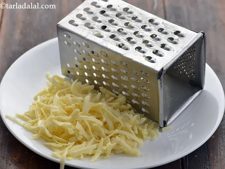 Step 10 – Grate a block of cheese and measure &frac12; cup and keep aside.