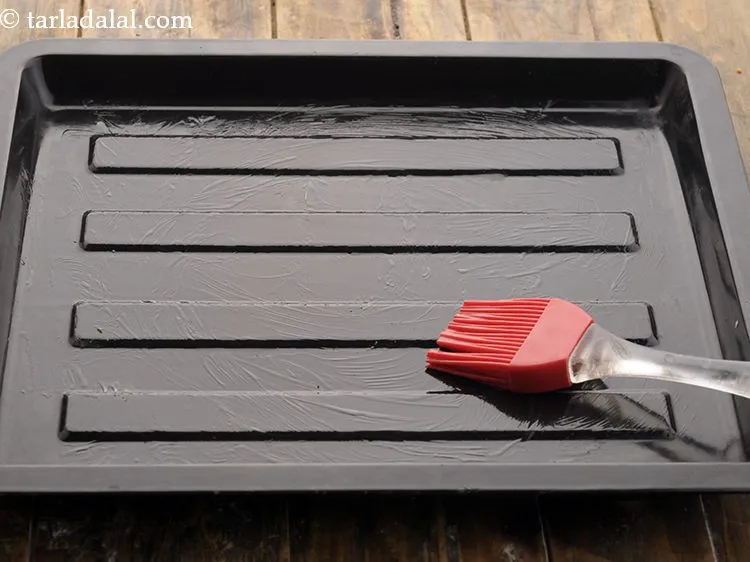 Step 9 – Grease the baking tray with butter.&nbsp;