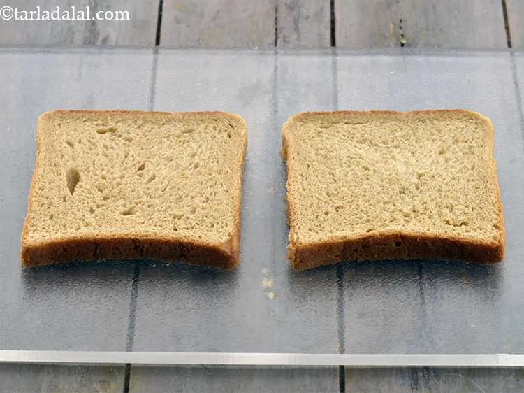Step 16 – On a clean and dry surface, keep 2 whole wheat bread slices. You can either …