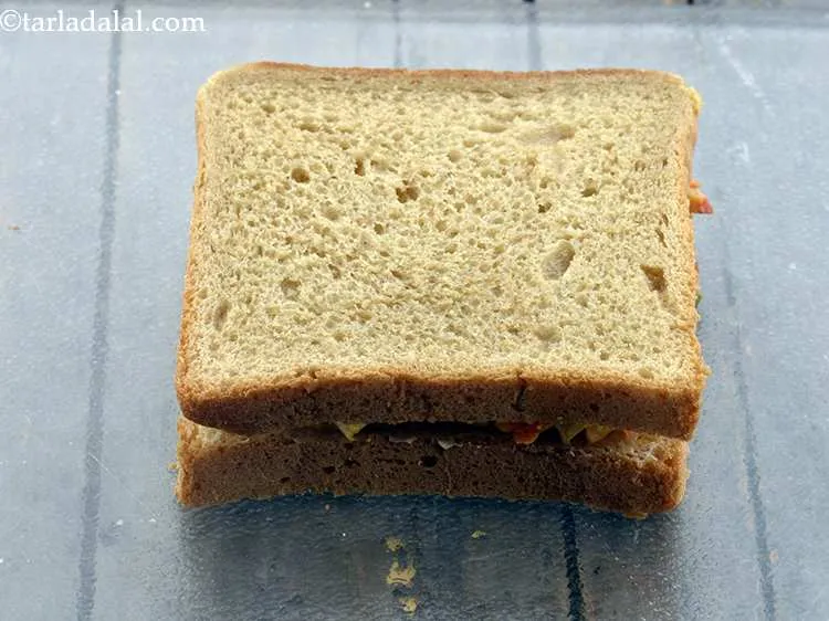 Step 19 – Place the other bread slice over the filling, buttered side facing downwards.&nbsp;
