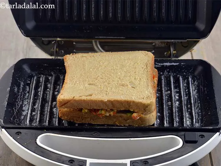 Step 22 – Place the sandwich on the griller, buttered side facing upwards.
