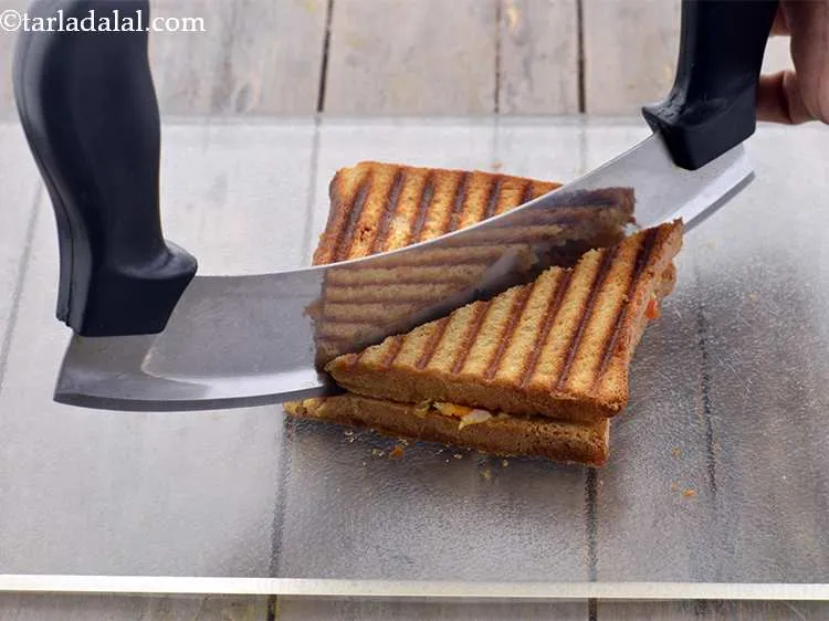 Step 25 – Cut the <strong>Cheesy onion grilled sandwich</strong> diagonally into 2 equal pieces. You can also cut …