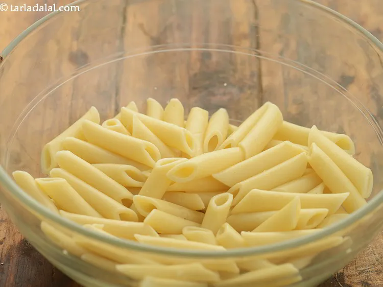 Step 22 – To prepare <strong>cheesy penne pasta</strong>, in a bowl take boiled and drained penne. You can …