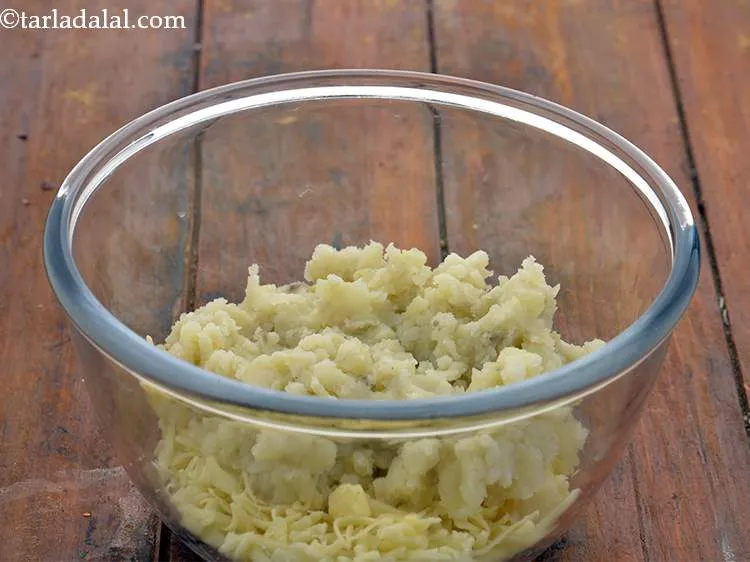 Step 12 – To this, add the boiled, peeled and mashed potatoes.