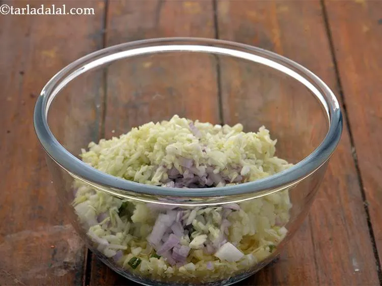 Step 13 – Further, add the onions and cabbage in the bowl.