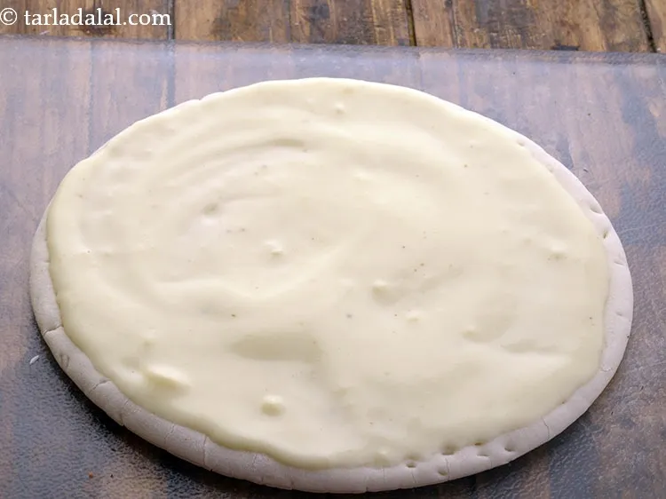 Step 24 – Spread a portion of the cheese sauce.