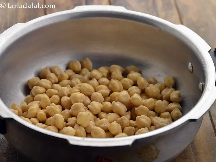 Step 33 – Transfer the soaked chana to a pressure cooker.