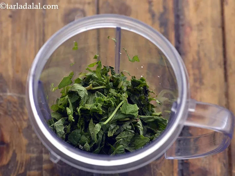Step 12 – For preparing a refreshing mint dressing, in a mixer jar, take chopped mint leaves.