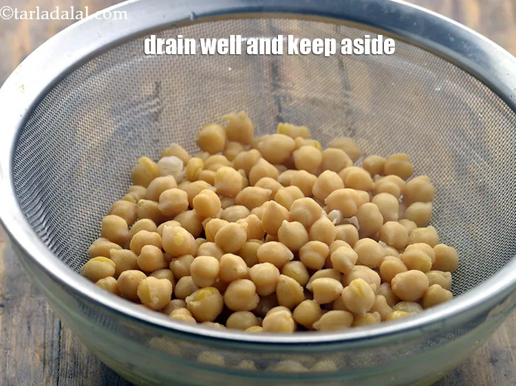 Step 8 – <meta charset="UTF-8" />Drain the semi cooked kabuli chana using a strainer and keep aside.<br /> …