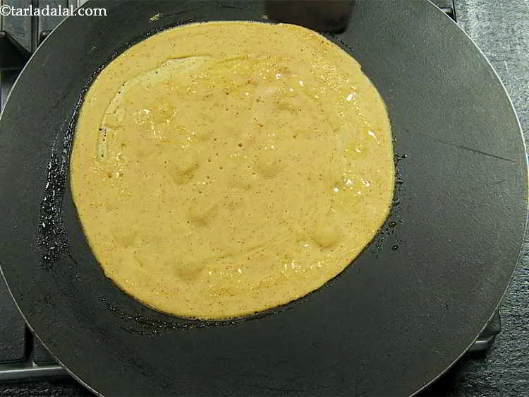 Step 15 – Cook on a high flame till the chilla turns golden brown in colour on the …