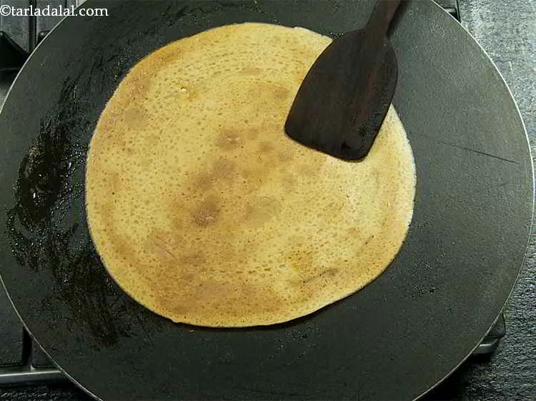 Step 16 – Flip the <em><strong>chilla</strong></em> and cook on the other side as well, till it turns golden …