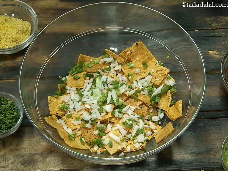 Step 19 – Now add the finely chopped spring onion whites and greens to the <strong>chilla</strong> pieces.