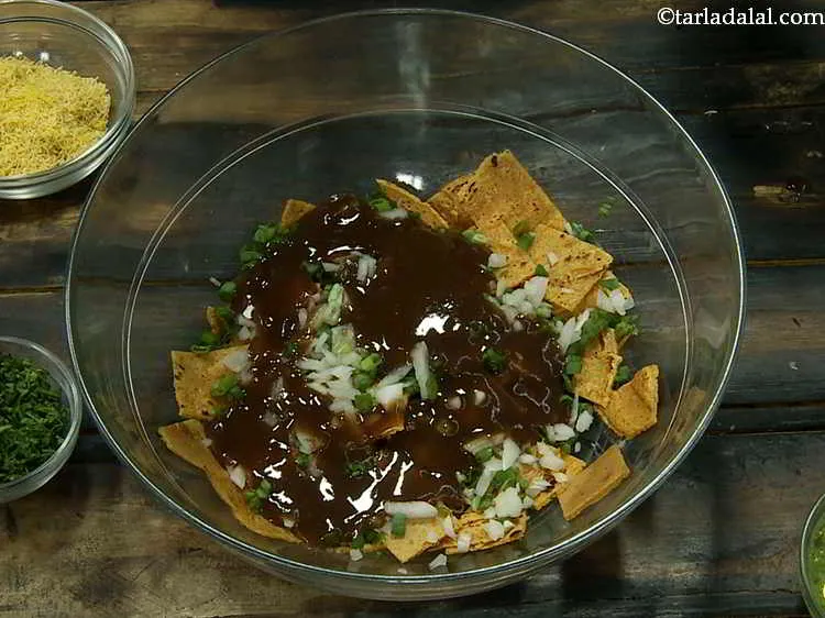 Step 20 – Add the khajur imli ki chutney. Here is the detailed recipe for <a href="https://www.tarladalal.com/Khajur-Imli-ki-Chutney-Sweet-Tamarind-Chutney-2796r"><strong>sweet chutney</strong></a>.