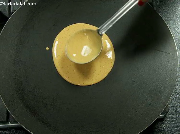 Step 12 – Pour a ladleful of the chilla batter on it.