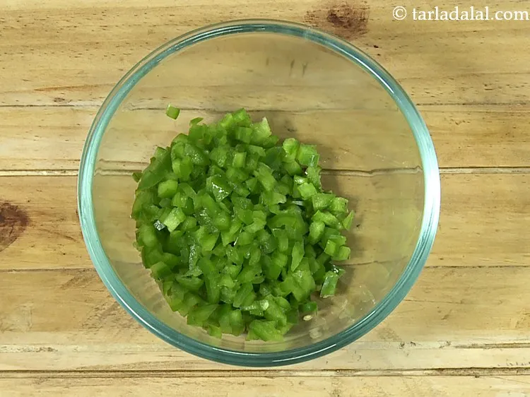 Step 3 – Add finely chopped capsicum. They give a nice bite to the <strong>chilli cheese paratha recipe</strong>. …