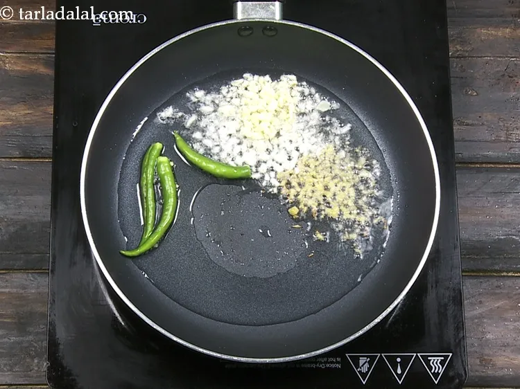 Step 32 – Add 3&nbsp;<a href="https://www.tarladalal.com/glossary-slit-green-chillies-1856i">green chillies , slit</a>.