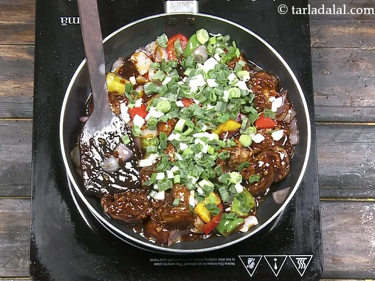 Step 41 – Switch off the flame and add the spring onions.