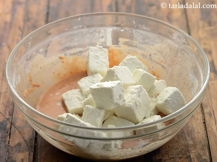 Step 12 – Once the batter is ready, add the cornflour coated paneer to it.&nbsp;