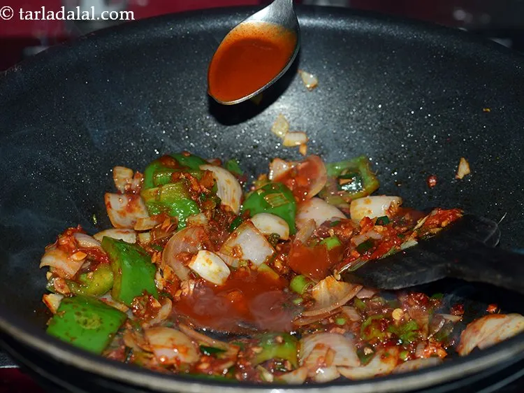 Step 29 – Add red chili sauce. You can adjust the quantity according to your preference of spice.