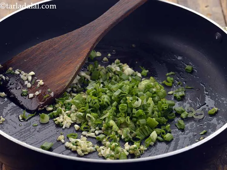 Step 20 – Add the spring onion whites and greens.