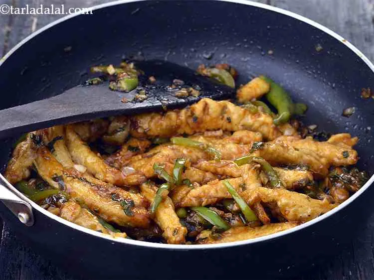 Step 21 – Add the deep-fried babycorn, mix well and cook on a medium flame for 1 to …