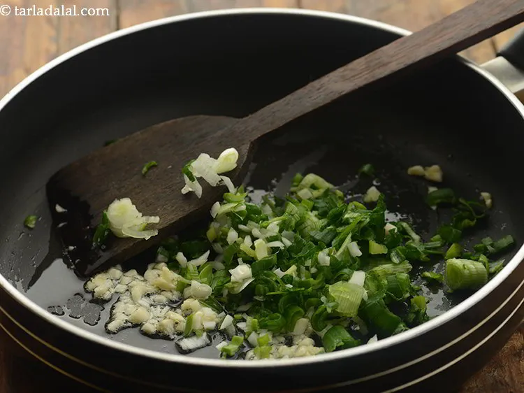 Step 7 – Add spring onion whites and greens.