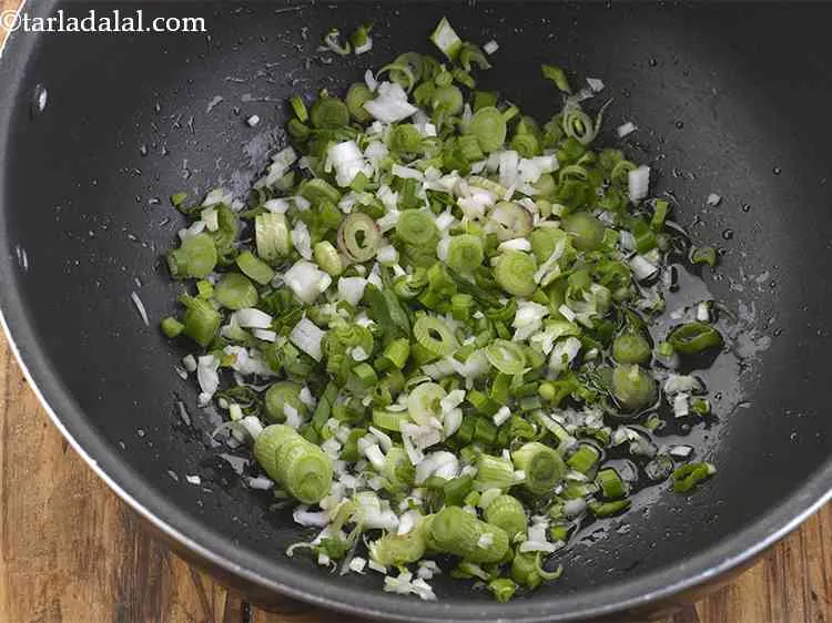 Step 18 – Add the chopped spring onion whites and greens.