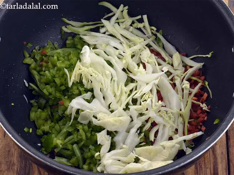 Step 23 – Also, add the shredded cabbage.
