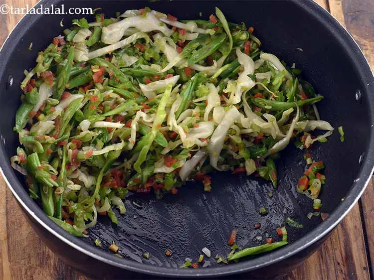 Step 25 – Move the vegetables to the side of the pan.