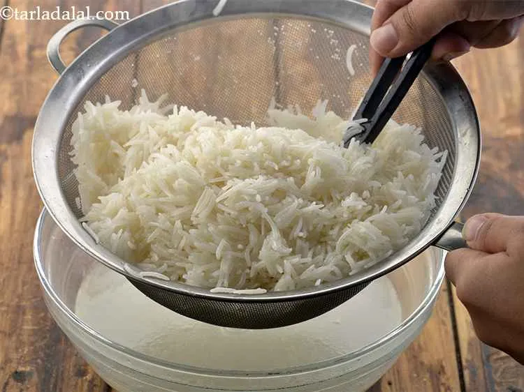 Step 12 – Toss the rice in it. Ensure each grain is coated well with oil.