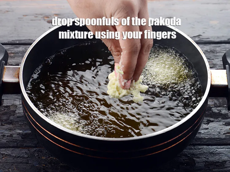 Step 12 – Drop spoonfuls of the pakoda mixture using your fingers. Do not fry them over low …