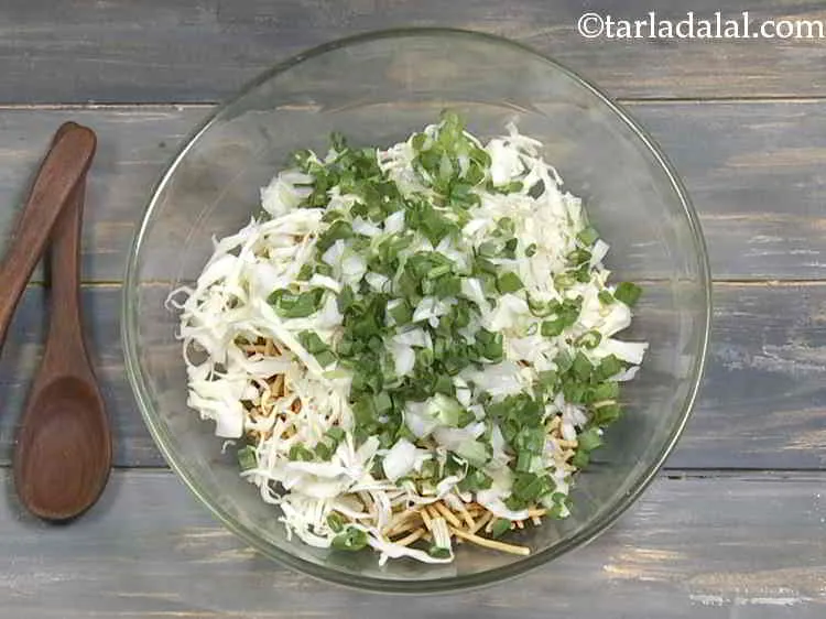 Step 9 – Now add the chopped spring onions whites and greens. You can also slice them.
