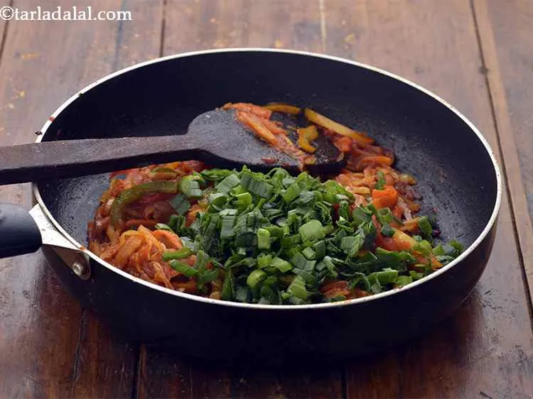 Step 9 – Switch off the flame, add the spring onion greens.