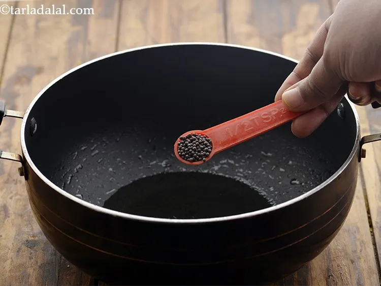 Step 10 – Once the oil is hot, add mustard seeds.