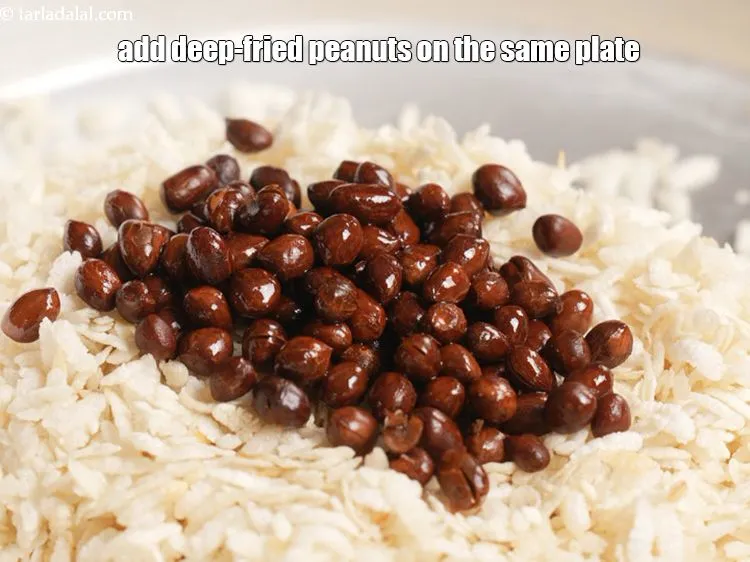 Step 11 – Add deep fried peanuts to the same plate of fried jada poha.