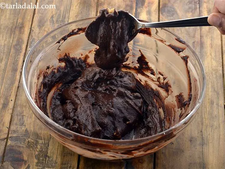 Step 18 – The <strong>eggless chocolate brownie batter</strong> should be of dropping consistency which means when you take …