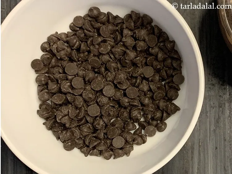 Step 24 – Add 1/2 cup&nbsp;<a href="https://www.tarladalal.com/glossary-chocolate-chips-325i">chocolate chips</a>. Learn to make <a href="https://www.tarladalal.com/how-to-make-homemade-chocolate-chips-42499r" target="_blank"><strong>chocolate chips at home</strong></a>.
