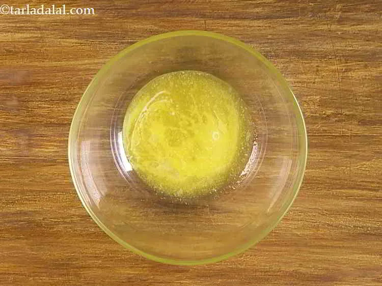 Step 12 – Now, take a large and wide mouthed bowl and add the butter into it.