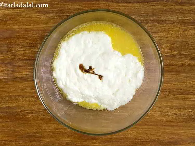 Step 15 – Add vanilla essence to enhance the flavour of the&nbsp;<strong>Eggless</strong>&nbsp;<strong>Chocolate Fudge Cake</strong><strong>.</strong>