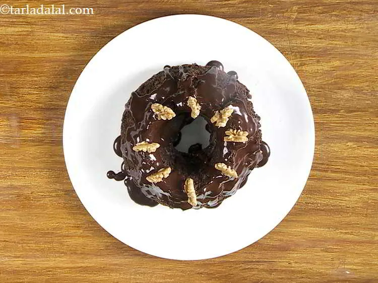 Step 27 – Garnish with a few walnuts and serve the&nbsp;<strong>&nbsp;</strong><strong>Eggless</strong>&nbsp;<strong>Chocolate Fudge Cake</strong>&nbsp;immediately.