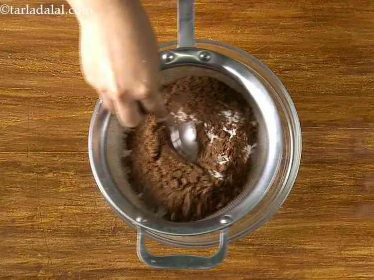 Step 11 – Push the flour down with the help of a spoon. Sieving the flour aerates it …