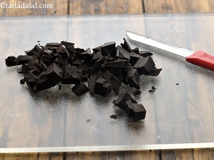 Step 3 – Take a slab of dark chocolate and place it on a chopping board. Roughly chop …