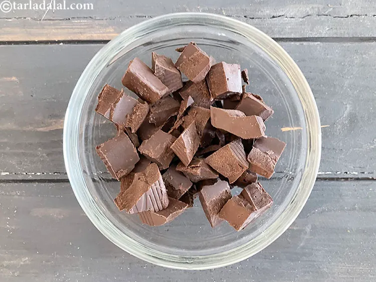 Step 19 – For the filling, add 2 cups&nbsp;roughly&nbsp;<a href="https://www.tarladalal.com/glossary-chopped-dark-chocolate-792i">chopped milk chocolate</a>&nbsp;or&nbsp;<a href="https://www.tarladalal.com/glossary-dark-chocolate-plain-chocolate-324i">dark chocolate</a> in a microwave-safe bowl.