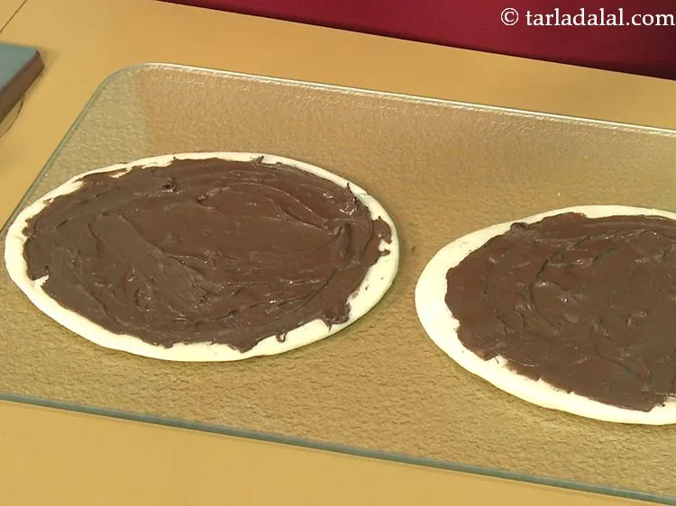 Step 25 – Spread 2 tbsp of nutella evenly over each pizza base. You can use any ther …